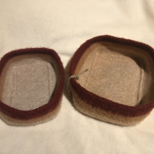 Two felted bowls in cream, tan and rust